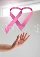 Open hand with pink ribbon for breast cancer awareness