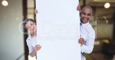 Business people holding blank card in office