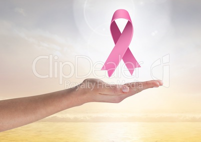 Open hand with pink ribbon for breast cancer awareness