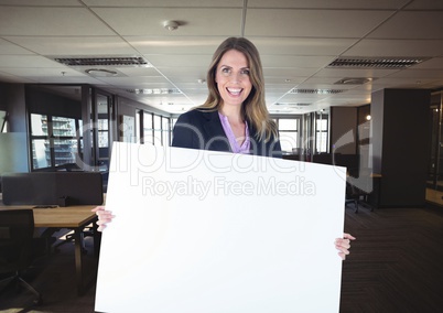 Happy business woman holding blank card in office