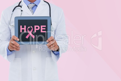 Doctor holding a tablet with a breast cancer awareness ribbon on screen