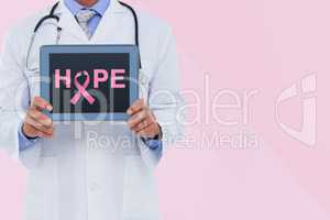 Doctor holding a tablet with a breast cancer awareness ribbon on screen