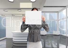 Business woman holding blank card in office