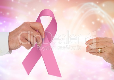 Passing hands with pink ribbon for breast cancer awareness
