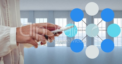 Hand and phone next to Colorful mind map over bright windows background