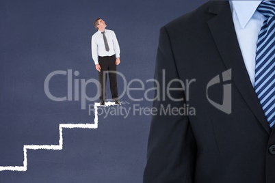 Small business man on stairs looking to a big business man