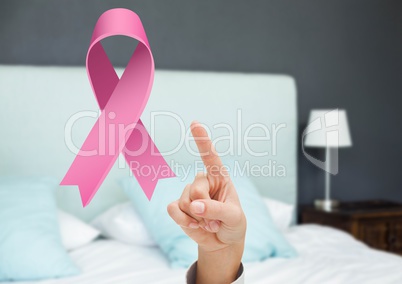 Pointing hand with pink ribbon for breast cancer awareness