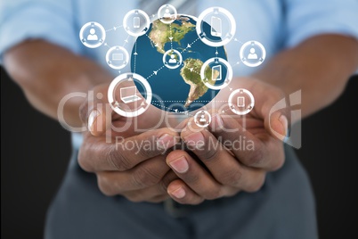 Business man holding a globe with connectors