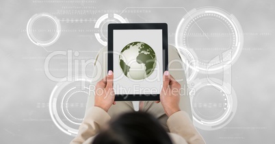 Business woman holding a tablet with a globe with connectors