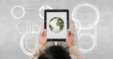 Business woman holding a tablet with a globe with connectors