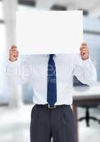 Business man holding blank card in office