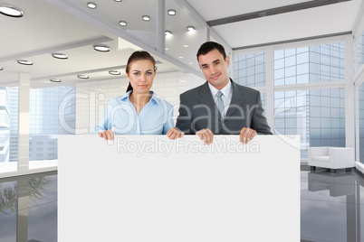 Business people holding blank card in office