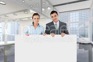 Business people holding blank card in office