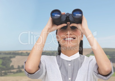 Businesswoman in nature with binoculars