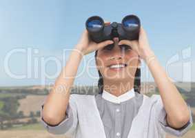 Businesswoman in nature with binoculars