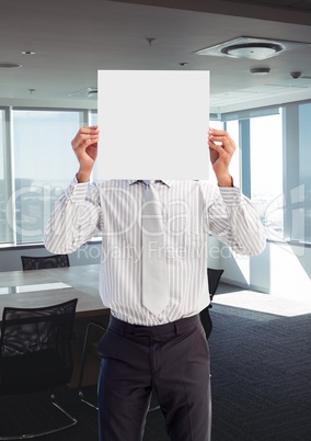 Business man holding blank card in office
