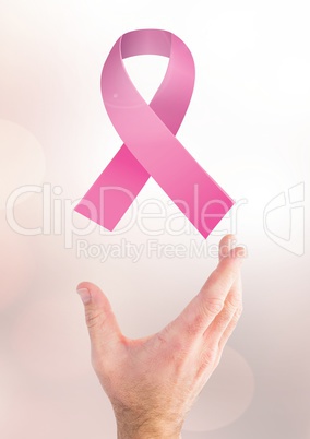 Open hand with pink ribbon for breast cancer awareness