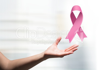 Open hand with pink ribbon for breast cancer awareness