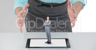 Big business woman with open hands and small business man on a tablet