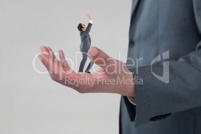 Scared small business man on the big business man hand