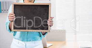 Business woman holding blank card in office