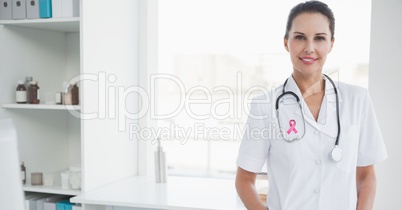 Doctor woman with breast cancer awareness ribbon