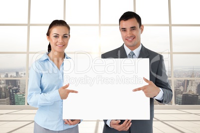 Business people holding blank card in office