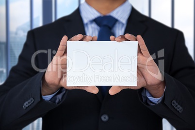 Business man holding blank card in office