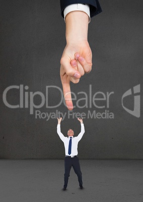 Big business man hand pointing to a small scared business man