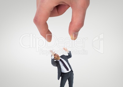 Big hand trying to catch a small scared business man
