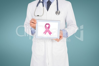 Doctor holding a tablet with a breast cancer awareness ribbon on screen