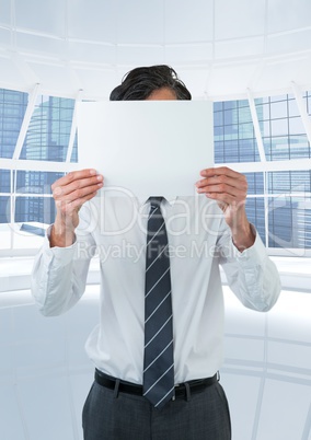 Business man holding blank card in office