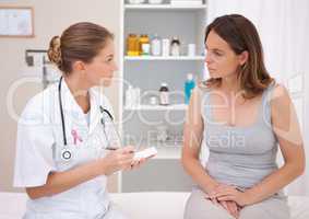 Doctor woman with breast cancer awareness ribbon and patient