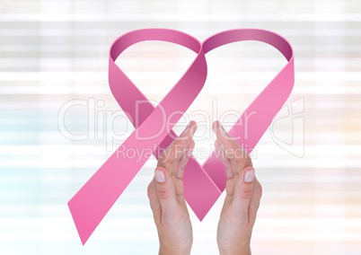 Open hands with pink ribbon for breast cancer awareness