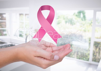 Open hansd with pink ribbon for breast cancer awareness