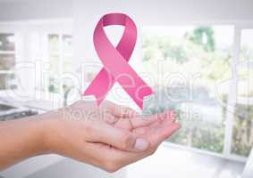 Open hansd with pink ribbon for breast cancer awareness