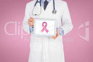 Doctor holding a tablet with a breast cancer awareness ribbon on screen