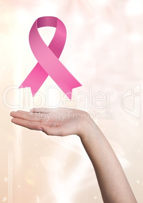 Open hand with pink ribbon for breast cancer awareness