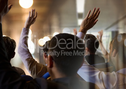 Business people with hands raised up at conference