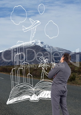 Business man drawing travel icons on the road