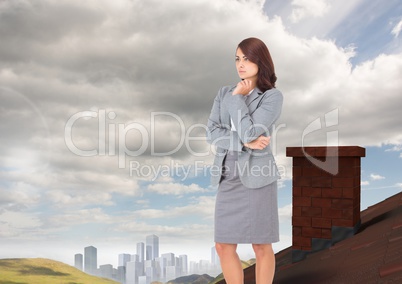 Businesswoman standing on Roof with chimney in country with city in distance