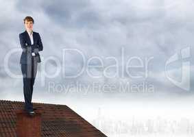 Businesswoman standing on Roof with chimney and cloudy city
