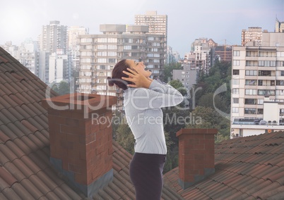Businesswoman standing on Roofs with chimney contrasting with apartment blocks