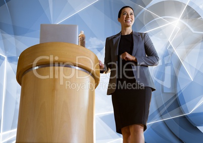 Businesswoman on podium speaking at conference with futuristic shapes