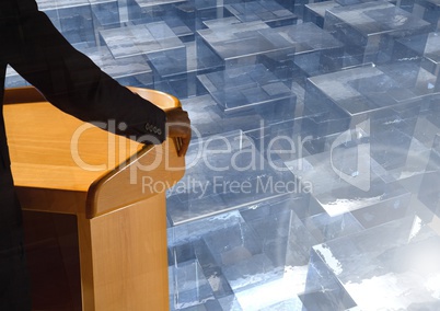 Businessman on podium speaking at conference with glass cubes