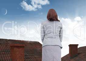 Businesswoman standing on Roofs with chimney and and blue sky