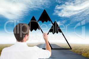 Business man drawing mountains on the road