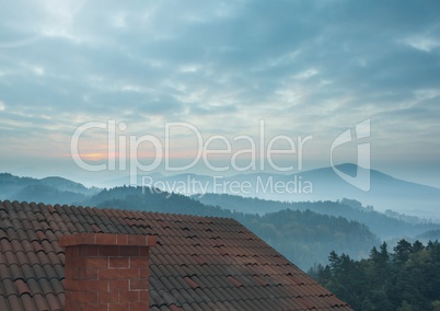 Roof with chimney and misty mountain landscape