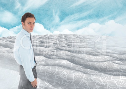 Businessman in sea of documents under sky clouds