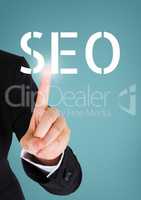 Hand interacting with SEO business text against blue background